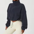Close-up of navy blue fleece jacket with high neck zipper and adjustable drawstring hem - S / Tops / Navy Blue