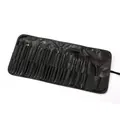 Detailed view of a 24-piece professional black makeup brush set in a roll-up pouch - 24-Piece Set / Black