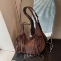 Brown suede fringe hobo bag with adjustable strap in American wasteland style - Brown