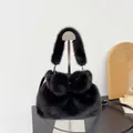 Elegant black faux mink fur handbag with bow detail and adjustable strap for winter. - Black