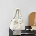 Elegant white faux fur handbag with plush bow detail and adjustable shoulder strap. - White