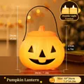 Handheld orange LED Halloween pumpkin lantern with handle for trick-or-treating decorations - Ghost Face (Dual Light)