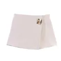 Front view of an elegant beige asymmetric skort with a decorative gold metal buckle. - XS / Bottoms / Ivory