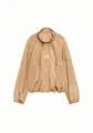 Detail view of a stylish champagne nylon jacket with stand collar and pleat accents. - Champagne Gold