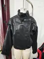 Detail of oversized black faux leather jacket with stand-up collar on mannequin - S / Tops / Black