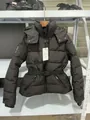 Detailed view of black waist-cinching puffer jacket with hood and belt on a rack - M / Tops / Black