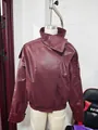Detail view of a wine red faux leather bomber jacket displayed on mannequin - S / Tops / Burgundy