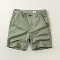 Vintage-style men's olive green casual cotton shorts with relaxed fit and button fly. - Light Army Green