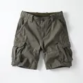 Vintage-style men's olive green cargo shorts featuring multiple pockets and a relaxed straight fit - 38 / Bottoms / Dark Army Green
