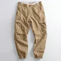 Men's khaki cargo jogger pants with large side pockets and elasticated tapered leg cuffs. - 38 / Bottoms / Khaki