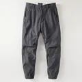 Retro men's gray fleece-lined cargo pants featuring pleated knee detail and elastic cuffs. - 38 / Bottoms / Dark Gray