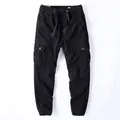 Durable men's black cotton cargo jogging pants featuring elastic waist and drawstrings - S / Bottoms / Black