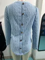 Macro view of dark button detailing on light blue textured long sleeve top with curved hem - S / Tops / Light Blue
