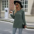 Detail view of women's casual knit top featuring side pockets and elegant puffy sleeves - Army Green
