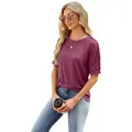 Woman wearing a stylish burgundy raglan sleeve T-shirt with button details and blue jeans - Burgundy