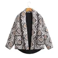 Detail view of ethnic print quilted jacket with black contrast trim and lining - S / Tops / As Shown