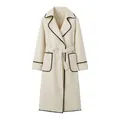 Detailed view of cream-colored belted wool coat with black scalloped edge stitching - S / Tops / White