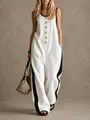 Detail view of sleeveless white jumpsuit featuring contrast side stripes and gold buttons. - S / Top And Bottom / White