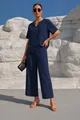 Vista dettagliata del completo con top blu scuro con scollo a V e pantaloni a gamba larga. - Taglia S / Top E Pantaloni / Blu navy