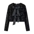 Close-up detail of a sparkly black sequined jacket with large satin bow accents. - XS / Tops / Black