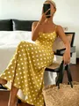 Elegant yellow spaghetti strap maxi dress with white polka dots in a resort setting - S / Yellow