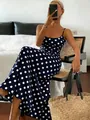 Elegant navy blue polka dot maxi dress with spaghetti straps shown in a lifestyle setting - S / Navy Blue