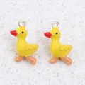 Detail shot of three-dimensional yellow enamel duck charms for DIY jewelry making - Duck / 1 Piece