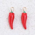 Detailed close-up of two red enamel chili pepper pendants for jewelry making - Little Pepper / 1 Piece