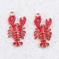 Detailed macro view of two red enamel lobster alloy pendants with gold-plated edges - Lobster / 1 Piece