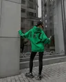 Rear view of a stylish green oversized hoodie featuring bold black BLAKE text print detail - Green