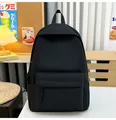 Detailed view of a minimalist black backpack in a cozy Japanese-style room setting - Black