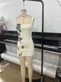 Detailed view of a white bodycon mini dress with colorful tropical beaded sequin patches - XS / Dress (ZNSBA2088) / Off White