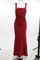Detailed view of a red satin evening gown with elegant ruching on a transparent mannequin. - XS / Dresses / Burgundy