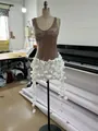 Detailed close-up of a sequined cocktail dress featuring a 3D white floral petal skirt. - XS / Tops / White Coffee
