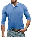 Close-up detail of blue men's long sleeve Henley shirt with white contrast trim and buttons - S / Tops / Light Blue