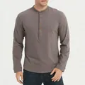 Detail view of a gray long-sleeved Henley shirt showing buttoned placket and fabric texture. - S / Tops / Dark Gray