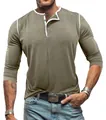 Close-up detail of men's olive green long-sleeve Henley shirt with white contrast trim - Khaki