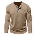 Detailed view of a men's khaki long-sleeve Henley shirt with plaid trim on the placket. - S / Tops / Khaki