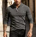 Close-up of a men's long-sleeved charcoal grey polo shirt featuring plaid collar details - Dark Gray