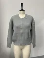 Close-up detail of a grey ribbed knit cardigan featuring a full front zipper on a mannequin. - L / Tops / Gray