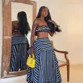 Model wearing a blue and black striped tube top and high-waisted maxi skirt set - S / Tops / Blue Stripe