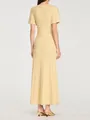 Vista posteriore di un elegante abito lungo in maglia gialla con paillettes e linea aderente - Taglia S / Pantaloni e gonne / Giallo