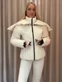 Close-up detail of women's white padded ski jacket featuring detachable hood and slim waist design - S / Tops / White