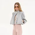 Detailed view of stylish gray cropped trench coat featuring pleated padded shoulders and stand collar - Gray