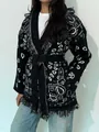 Detailed view of women's ethnic fringe knit cardigan with paisley pattern and tie belt - S / Tops / Black and White