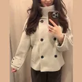 Close-up detail of women's commuter stand-collar short wool coat with stylish black buttons - Oatmeal
