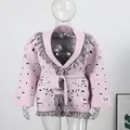 Women's ethnic style pink knit cardigan featuring tassel trim and a belted waist design - M / Tops / Pink
