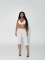 Detail of white two-piece set featuring black polka dots halter top and ruffled capris - S / Top And Bottom / White