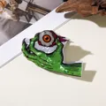 Spooky Halloween zombie hand with eyeball hair claw clip in green pearlescent finish - Hand Holding Eyeball