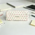 Close-up of cream canvas pencil case featuring red star patterns and a central May Rabbit label - Milk White with Red Stars